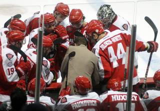 Down by a goal, Wranglers head coach Ryan Mougenel, center, calls his team together to draw up a play during a timeout taken with just over a minute remaining in the third period of play against the Alaska Aces on Friday night.