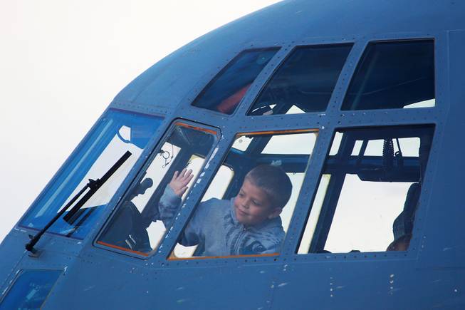 Nicholas Perkins looks out the window on the flight deck of a C-130 during the annual Aviation Nation air show at Nellis Air Force Base Saturday, Nov. 10, 2012.