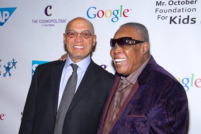 Hall of Famer Reggie Jackson, left, poses with singer Sam Cooke at the 8th All-Star Celebrity Classic at the Cosmopolitan Sunday, Nov. 11, 2012. The event raised funds for the Mr. October Foundation for Kids, a charity that supports minority students pursuing education in science and technology.
