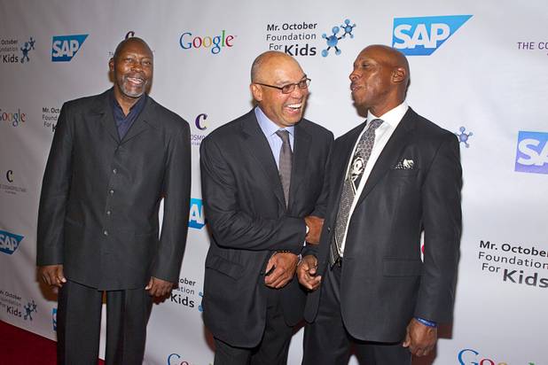 Reggie Jackson, center, laughs with R&B singer Jeffery Osborne as former MLB pitcher Dave Stewart looks on during Jackson's 8th All-Star Celebrity Classic at the Cosmopolitan Sunday, Nov. 11, 2012. The event raised funds for the Mr. October Foundation for Kids, a charity that supports minority students pursuing education in science and technology.