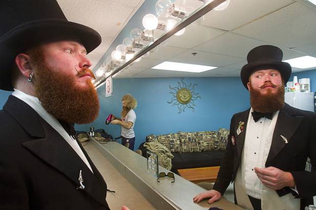 John Myatt, left, of Los Angeles looks over his beard in a grooming area during the third annual 2012 Beard Team USA National Beard and Moustache Championships at the Clark County Government Center amphitheater in downtown Las Vegas Sunday, November 11, 2012. Bob Engle of Portland, Ore. works on his beard in the background.