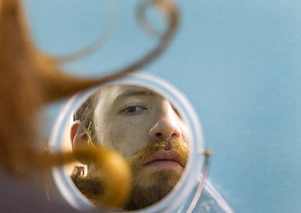 This photo was awarded second place in the "Best Feature Photo" category by the Nevada Press Association.  Thomas Smith of Dayton, Ohio works on his beard in a grooming area during the third annual 2012 Beard Team USA National Beard and Moustache Championships at the Clark County Government Center amphitheater in downtown Las Vegas Sunday, November 11, 2012. Smith was competing in the full beard free-style category.
