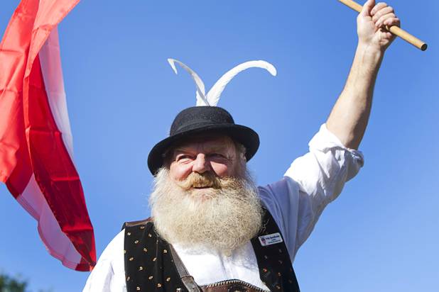 Fritz Sendlhofer holds the flag of Austria as he makes his entrance during the third annual 2012 Beard Team USA National Beard and Moustache Championships at the Clark County Government Center amphitheater in downtown Las Vegas Sunday, November 11, 2012.