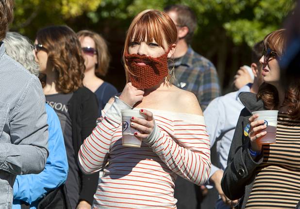 Ciara Hulse of St. George, Utah tries to fit in during the third annual 2012 Beard Team USA National Beard and Moustache Championships at the Clark County Government Center amphitheater in downtown Las Vegas Sunday, November 11, 2012.