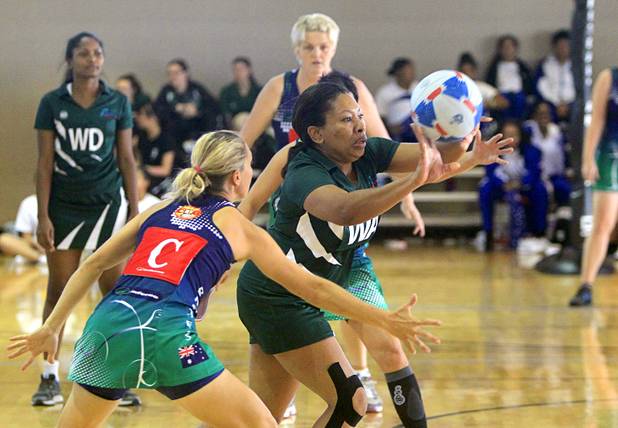 Opal Hill, center, of the Southeast Strikers passes the ball in the women's finals during the 2012 CallidusCloud U.S. Open Netball Championships at UNLV campus Sunday, November 11, 2012. Wendy Evans of the Brothers Netball Club of Australia team covers her at left.