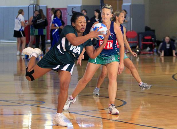 Opal Hill, left, of the Southeast Strikers, catches a pass as Sarah Dyer of Brothers Netball Club of Australia  looks on in the women's finals match during the 2012 CallidusCloud U.S. Open Netball Championships at UNLV campus Sunday, November 11, 2012.
