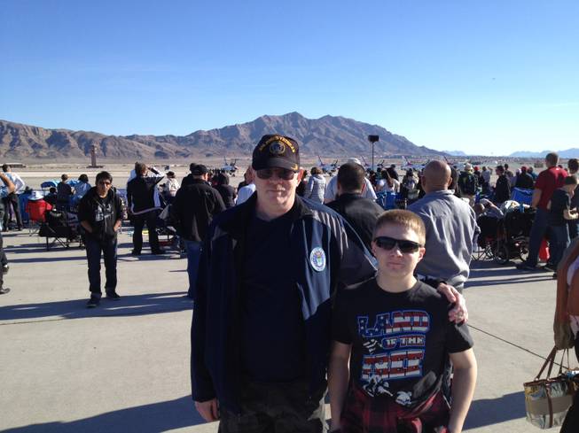 Air Force veteran Mark Goldstrom and his son Trace Goldstrom stand at the Aviation Nation air show at Nellis Air Force Base on Sunday, Nov. 11, 2012.  