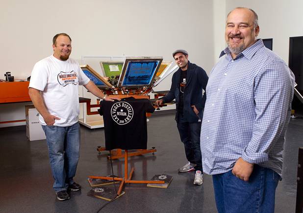 Justin Wallin, left, owner of Booze Brothers Beverage, Christian Escobedo, center, owner of the Half Full Artisan Shop, and Las Vegas Distillery founder George Racz poses in the retail shop next to the distillery in Henderson Monday, Nov. 12, 2012. The distillery, 7330 Eastgate Road, will celebrate the historic bottling of several new spirits -Nevada whiskey, rum, gin and moonshine- on Saturday, Nov. 17. Wallin and Escobedo will celebrate their grand openings.