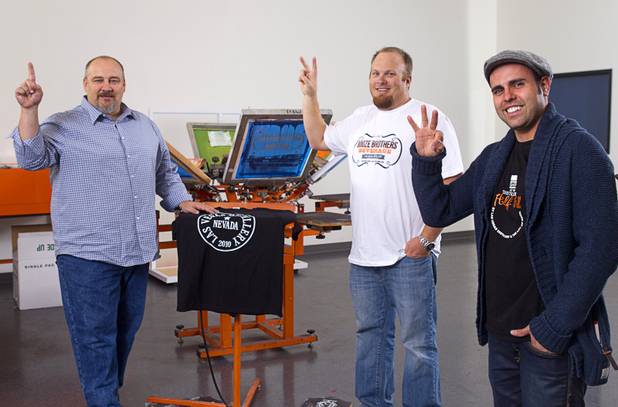 Las Vegas Distillery founder George Racz, left, Justin Wallin, center, owner of Booze Brothers Beverage, and Christian Escobedo, owner of the Half Full Artisan Shop, hold up fingers to show their position in Nevada's three tier structure for alcohol in Nevada. Racz is the producer, Wallin is the distributor, and Escobedo has the retail shop. Photo taken at the Half Full Artisan Shop in Henderson Monday, Nov. 12, 2012.