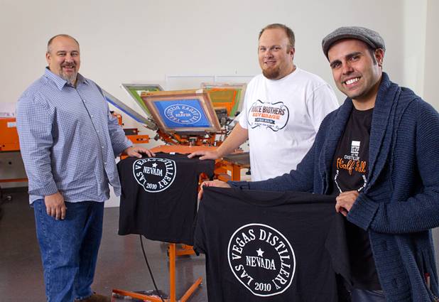 Las Vegas Distillery founder George Racz, left, Justin Wallin, center, owner of Booze Brothers Beverage, and Christian Escobedo, owner of the Half Full Artisan Shop, pose at the Half Full Artisan Shop in Henderson Monday, Nov. 12, 2012. The distillery, 7330 Eastgate Road, will celebrate the historic bottling of several new spirits - Nevada whiskey, rum, gin and moonshine - on Saturday, Nov. 17. Wallin and Escobedo will celebrate their grand openings.