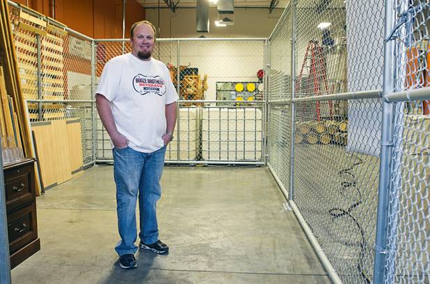 Justin Wallin, owner of Booze Brothers Beverage distribution company, stands in a fenced-in, distribution area inside the Las Vegas Distillery in Henderson Monday, Nov. 12, 2012. The distillery, at 7330 Eastgate Road, will celebrate the historic bottling of several new spirits -Nevada whiskey, rum, gin and moonshine- on Saturday, Nov. 17.  Booze Brothers and the Half Full Artisan Shop, a retail business adjacent to the distillery, will celebrate their grand openings.