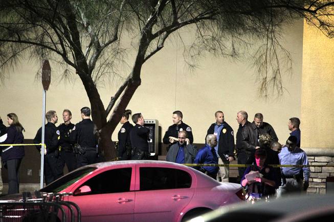 Law enforcement gather outside of an Albertsons grocery store where Henderson Police shot a man Wednesday afternoon at the corner of Lake Mead Parkway and Boulder Highway in Henderson on Wednesday, November 14, 2012.