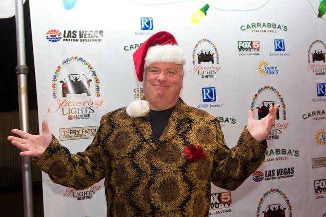 Kevin Burke of "Defending the Caveman" at Harrah's arrives on the red carpet during the grand opening of Glittering Lights at Las Vegas Motor Speedway on Thursday, Nov. 15, 2012.