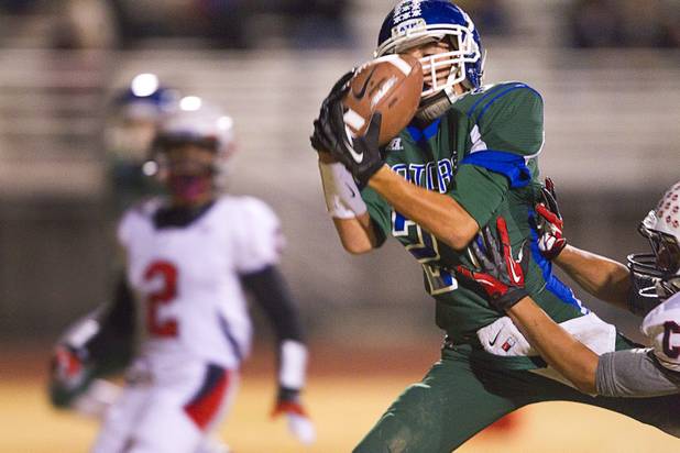 Green Valley's Markus Varner pulls in a pass that he carries in for Green Valley's first touchdown during the Sunrise regional semifinal against Coronado at Green Valley High School in Henderson Friday, November 16 , 2012.