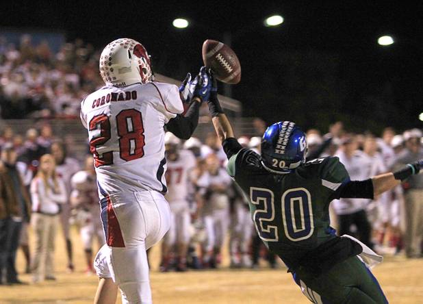 Green Valley's Cody Milner breaks up a end zone pass intended for Coronado's Chris Laliberte during the Sunrise regional semifinal at Green Valley High School in Henderson Friday, November 16 , 2012.