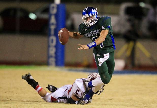 Coronado's Cosme Montenegro makes a diving tackle on Green Valley quarterback Christian Lopez during the Sunrise regional semifinal at Green Valley High School in Henderson Friday, November 16 , 2012.