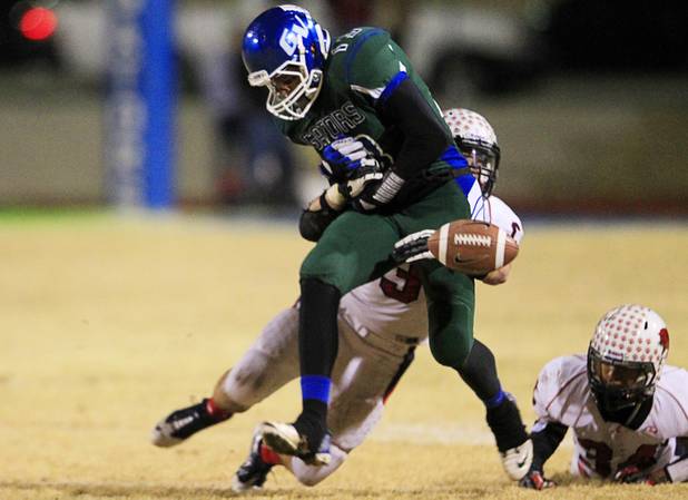Coronado's Dakota Brunger forces Green Valley's Kyler Chavez to fumble during the Sunrise regional semifinal at Green Valley High School in Henderson Friday, November 16 , 2012. Coronado recovered the fumble.