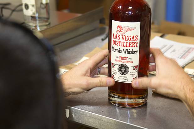 Mat Young of Park City, Utah applies a label to a bottle of Nevada whiskey during the Historic First Edition Day at the Las Vegas Distillery in Henderson Saturday, November 17, 2012. The event marks the first bottling of several new spirits and the grand opening of the Booze Brothers Beverage distribution company and the Half Full Artisan Shop at the Distillery, a retail store. The spirits include Nevada vodka, whiskey, gin, rum and moonshine.