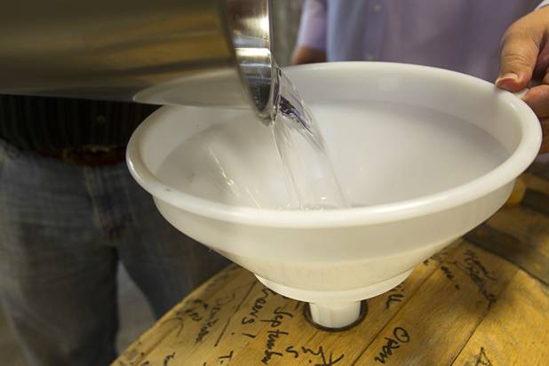 Tony Lepore uses a bucket to help fill a barrel with single malt whiskey during the Historic First Edition Day at the Las Vegas Distillery in Henderson Saturday, November 17, 2012. The event marks the first bottling of several new spirits and the grand opening of the Booze Brothers Beverages distribution company and the Half Full Artisan Shop at the Distillery, a retail store. The spirits include Nevada vodka, whiskey, gin, rum and moonshine.