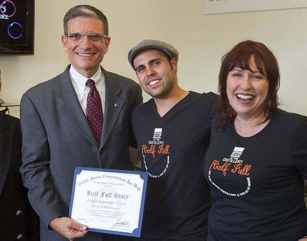 Congressman Joe Heck (R-NV) poses with Christian Escobedo, owner of the Half Full Artisan Shop, and Christian's mother during the Historic First Edition Day at the Las Vegas Distillery in Henderson Saturday, November 17, 2012. The event marks the first bottling of several new spirits and the grand opening of the Booze Brothers Beverages distribution company and the Half Full retail store. The spirits include Nevada vodka, whiskey, gin, rum and moonshine.