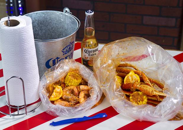 Bags of shrimp and snow crab at California Crab, a restaurant at 9560 S. Eastern Ave. Sunday, November 18, 2012. Shrimp, left, served with corn, lemon and potatoes, is $9.99 per pound. Snow crabs legs, right, are market priced. Bananas in Pajamas ($6.99) is a bowl of Magnolia ube, a Filipino purple yam ice cream, surrounded by small sticks of hot fried bananas.
