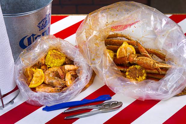 Bags of shrimp and snow crab at California Crab, a restaurant at 9560 S. Eastern Ave. Sunday, November 18, 2012. Shrimp, left, served with corn, lemon and potatoes, is $9.99 per pound. Snow crabs legs, right, are market priced. Bananas in Pajamas ($6.99) is a bowl of Magnolia ube, a Filipino purple yam ice cream, surrounded by small sticks of hot fried bananas.