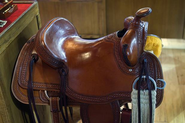 A hand-tooled saddle is displayed at the Pinto Ranch western wear store in the Fashion Show Mall Monday, November 19, 2012. The saddles are made in-house at the Pinto Ranch store in Houston. Prices start at $3,400.