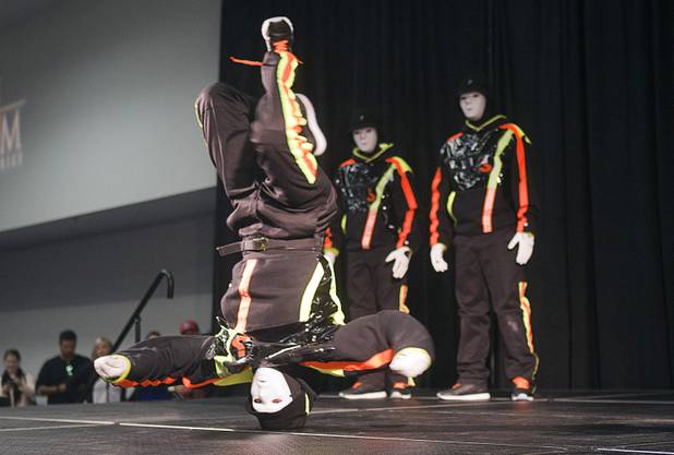 A Jabbawockeez dancer spins on his head during the annual Las Vegas Sun Youth Forum at the Las Vegas Convention Center Tuesday, November 20, 2012.