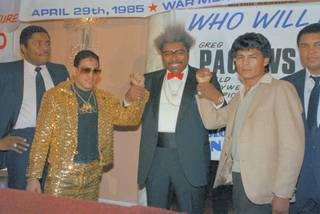 Promoter Don King, holds up the fists of Hector ?Macho? Camacho former World Super Featherwight Champion (left) and Roque Montoya (right) Mexican lightweight champ on March 7, 1985. Both will fight a 12 rounder for North American lightweight crown which is vacant. Fight will in Buffalo on April 29th, with other bouts. 