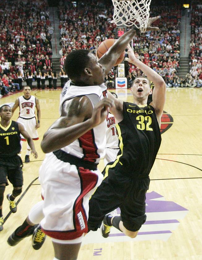 UNLV forward Quintrell Thomas defends Oregon forward Ben Carter during their game Friday, Nov. 23, 2012 in the Global Sports Classic. Oregon upset the 18th-ranked Rebels 83-79.