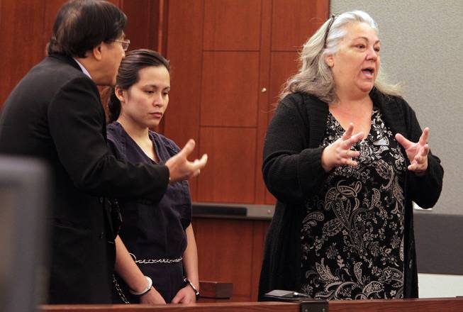 Sounilak Ouchlaeun, center, appears in court with interpreter Thirawat Apichonrattanakorn, left, and public defender Christy Craig, right, at the Regional Justice Center in Las Vegas on Tuesday, November 27, 2012. Ouchlaeun is charged with murder with a deadly weapon for running over her boyfriend with a car.