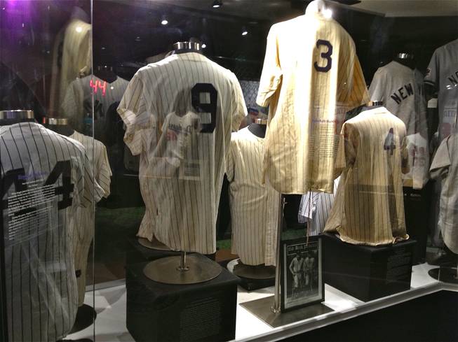 A display of New York Yankees jerseys worn in games by legends, including (from left) Reggie Jackson, Roger Maris, Babe Ruth and Lou Gehrig, are featured at Score!, the interactive fantasy sports exhibit at the Luxor in Las Vegas.