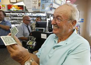 Wes Prinzen, of Fountain Hills, Ariz., smiles as he takes away his modest $4 winnings, at a 4 Sons Food Store where one of the winning tickets in the $579.9 million Powerball jackpot was purchased, Nov. 29, 2012, in Fountain Hills, Ariz.