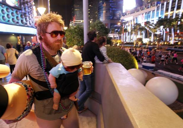 A street performer, dressed as Alan Garner, the character portrayed by Zach Galifianakis in The Hangover movies, watches runners during the Zappos.com Rock 'n' Roll Las Vegas Marathon Sunday, Dec. 2, 2012.