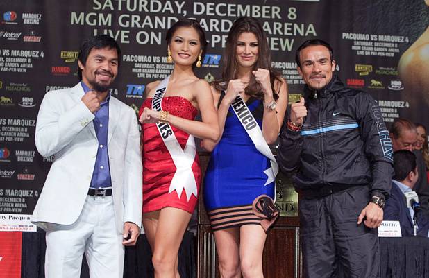 Filipino boxer Manny Pacquiao, left, and Juan Manuel Marquez of Mexico pose with Miss Universe contestants Miss Philippines Janine Tugonon and Miss Mexico Karina Gonzalez during a news conference at the MGM Grand Wednesday, Dec. 5, 2012. Pacquiao and Marquez will fight for a fourth time in a welterweight bout at the MGM Grand Garden Arena Saturday.