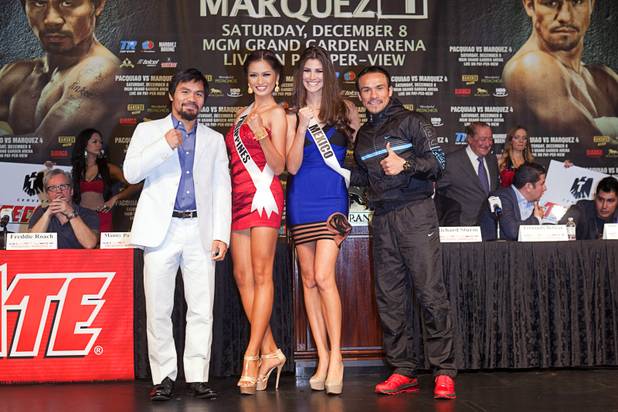 Filipino boxer Manny Pacquiao, left, and Juan Manuel Marquez of Mexico pose with Miss Universe contestants Miss Philippines Janine Tugonon and Miss Mexico Karina Gonzalez during a news conference at the MGM Grand Wednesday, Dec. 5, 2012. Pacquiao and Marquez will fight for a fourth time in a welterweight bout at the MGM Grand Garden Arena Saturday.