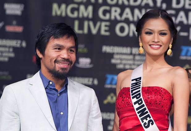 Filipino boxer Manny Pacquiao poses with Miss Universe contestant Miss Philippines Janine Tugonon during a news conference at the MGM Grand Wednesday, Dec. 5, 2012. Pacquiao and Juan Manuel Marquez of Mexico will fight for a fourth time in a welterweight bout at the MGM Grand Garden Arena Saturday.