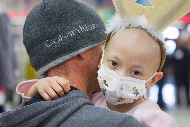 Cancer patient Junaisy Vargas, 5, is held by her father Antonio Vargas during an annual Shop With A Cop event at the Target store at 2189 W. Craig Rd. in North Las Vegas, Wednesday, December 5, 2012.