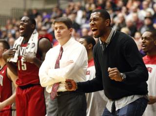 UNLV players Mike Moser, right, and Anthony Bennett, left, celebrate from the bench on both sides of coach Dave Rice during the second half of their game in Portland, Ore., Tuesday, Dec. 4, 2012. Bennett led UNLV in scoring with 18 points as they won 68-60.