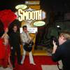 Showgirl Jennifer Autry and Elvis impersonator Brendan Paul pose for a photo with contest winner Jeff Paul during an event to honor Paul who won an Expedia.ca contest Thursday, Dec. 6, 2012 at the Neon Museum.