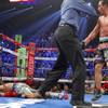Juan Manuel Marquez is directed to a neutral corner after knocking out Manny Pacquiao during the sixth round of their welterweight fight at MGM Grand Garden Arena on Saturday, Dec. 8, 2012.
