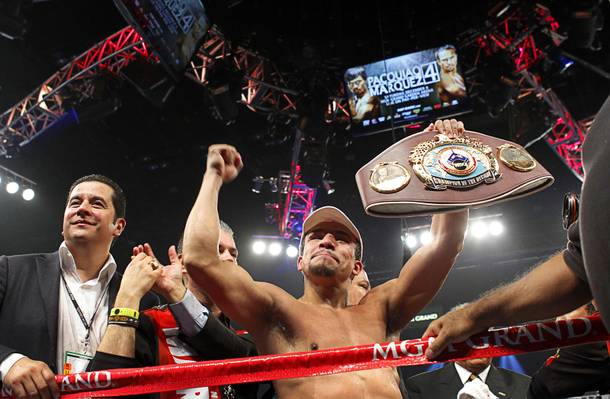 Juan Manuel Marquez of Mexico celebrates his 6th round knock out victory over Manny Pacquiao of the Philippines during their welterweight fight at the MGM Grand Garden Arena in Las Vegas, Nevada December 8, 2012. boxing promoter Fernando Beltran is at left.