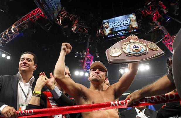 Juan Manuel Marquez of Mexico celebrates his 6th round knock out victory over Manny Pacquiao of the Philippines during their welterweight fight at the MGM Grand Garden Arena in Las Vegas, Nevada December 8, 2012. boxing promoter Fernando Beltran is at left.