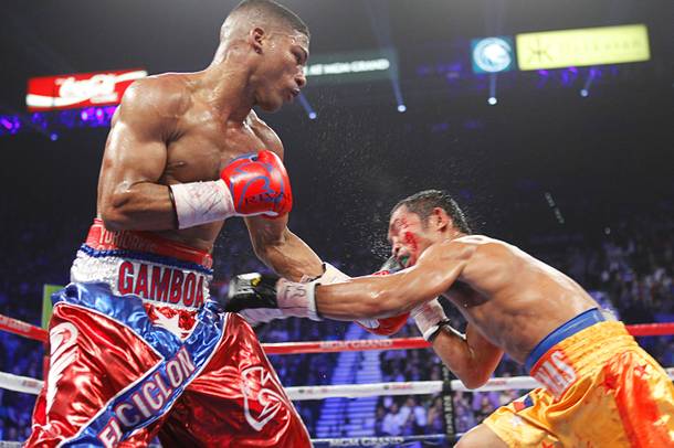 Yuriorkis Gamboa (L) of Cuba punches on Michael Farenas of the Philippines during their WBA interim super featherweight fight at the MGM Grand Garden Arena in Las Vegas, Nevada December 8, 2012.