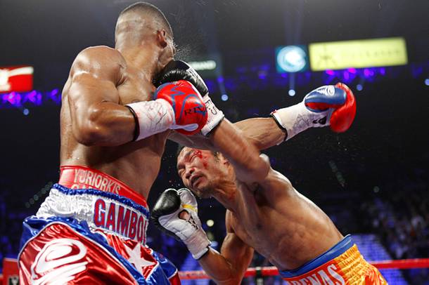 Yuriorkis Gamboa (L) of Cuba takes a punch from Michael Farenas of the Philippines during their WBA interim super featherweight fight at the MGM Grand Garden Arena in Las Vegas, Nevada December 8, 2012.
