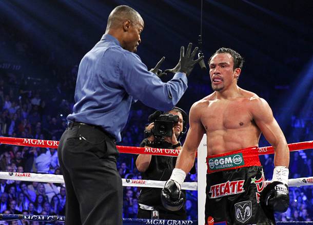Referee Kenny Bayless gives a count to Juan Manuel Marquez of Mexico after Marquez was knocked down by Manny Pacquiao of the Philippines in the fifth round of their welterweight fight at the MGM Grand Garden Arena in Las Vegas, Nevada December 8, 2012.