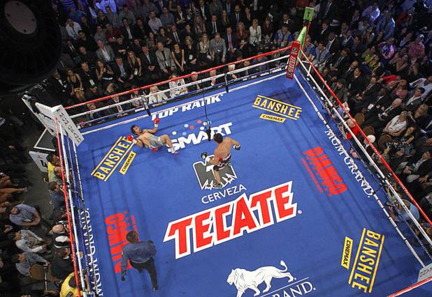 Manny Pacquiao of the Philippines is knocked down by Juan Manuel Marquez of Mexico in the third round of their welterweight fight at the MGM Grand Garden Arena in Las Vegas, Nevada December 8, 2012.