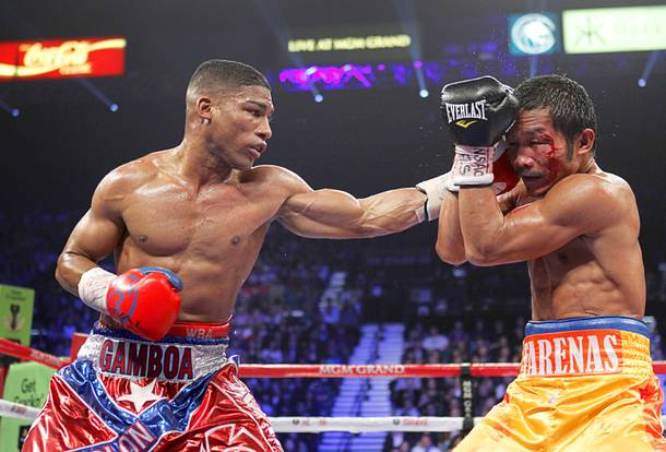 Yuriorkis Gamboa (L) of Cuba connects on Michael Farenas of the Philippines during their WBA interim super featherweight fight at the MGM Grand Garden Arena in Las Vegas, Nevada December 8, 2012.