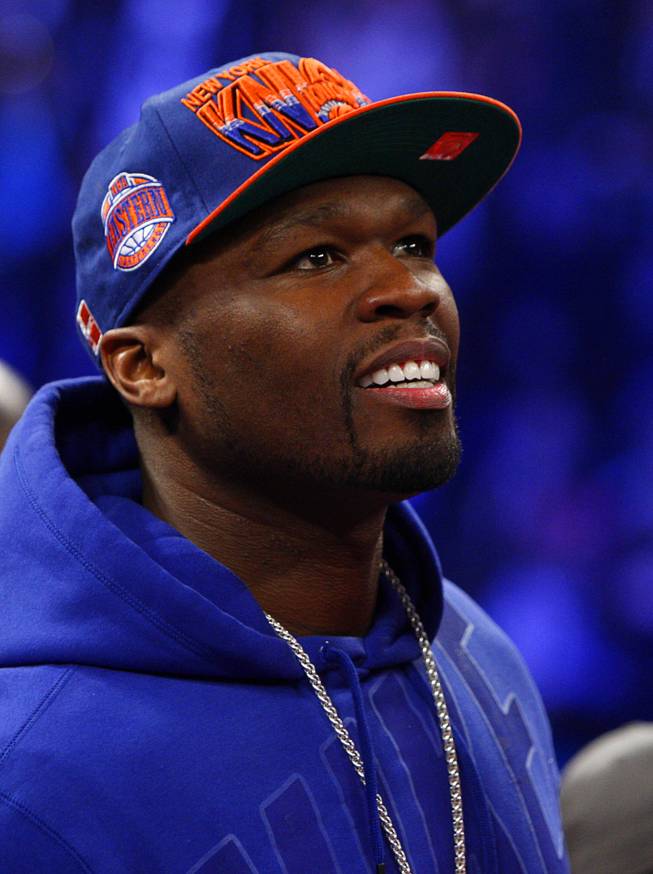 Rapper/actor Curtis "50 Cent" Jackson waits for the start of a WBA interim super featherweight fight between Yuriorkis Gamboa of Cuba and Michael Farenas of the Philippines at the MGM Grand Garden Arena in Las Vegas, Nevada December 8, 2012. Jackson is promoting Gamboa through SMS Promotions, his new boxing promotion company.