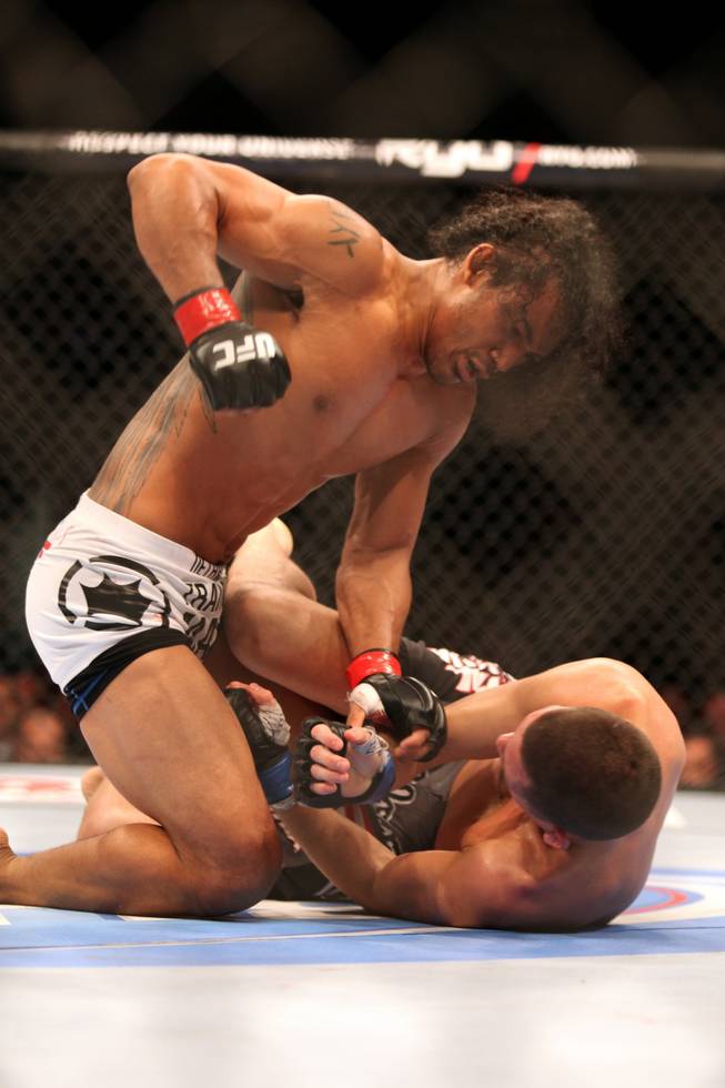 UFC lightweight champion Benson Henderson, top, in action against Nate Diaz during their mixed martial arts bout at a UFC on FOX 5 event in Seattle on Saturday, Dec. 8, 2012. Henderson retained his title via a unanimous five-round decision. 